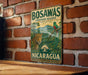 a vintage-style sign for the Bosawas Biosphere Reserve in Nicaragua, with a leopard and a bird on the sign.