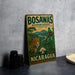 A vintage-style metal sign for Bosawas Biosphere Reserve in Nicaragua, featuring an illustration of a jaguar and a bird in a lush, tropical landscape.