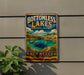 A vintage-style sign for Bottomless Lakes State Park in New Mexico, featuring a scenic landscape with a lake and mountains.