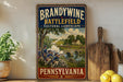 A vintage-style sign for Brandywine Battlefield Cultural Landscape in Pennsylvania, featuring a painting of soldiers in uniform and a scenic landscape.