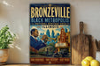 a vintage poster of a man playing a trumpet in front of a cityscape, with the text "BRONZEVILLE BLACK METROPOLIS NATIONAL HERITAGE AREA ILLINOIS" and "OUR HERITAGE - OUR HISTORY - OUR PRIDE" prominently displayed.