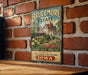 A vintage-style metal sign for the "Brucemore Estate" in Iowa, featuring a large illustration of a house surrounded by flowers and greenery.