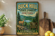 A vintage-style sign for the Buck Hill State Forest in New York, featuring a deer and a mountain landscape.