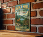 A vintage-style metal sign for Buck Hill State Forest in New York, featuring a deer and a mountain landscape.