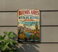 a vintage-style metal sign with a bird and desert landscape, mounted on a wall.