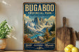 A vintage-style sign for Bugaboo Provincial Park in British Columbia, featuring a mountain landscape with a lake and pine trees.