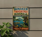 a sign for the Banaaki Tengkoko Minahasa Biosphere Reserve in Indonesia, with a tropical landscape and various wildlife depicted on the sign.