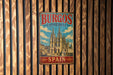 A vintage metal sign displaying the name 'BURGOS CATHEDRAL' and the word 'SPAIN' is hanging on a wooden wall.