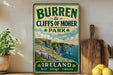 A vintage-style sign for Burren and Cliffs of Moher Park, featuring a scenic image of the cliffs and ocean.
