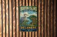 A vintage metal sign for Burton Island Nature Preserve in Delaware, featuring a blue heron and text promoting wildlife, hiking, birding, education, and conservation.