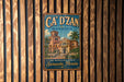 A vintage-style sign for "CA' D' ZAN MANSION" is displayed on a wooden wall, featuring an illustration of a building with palm trees.