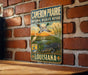 A vintage-style sign for the Cameron Prairie National Wildlife Refuge in Louisiana, featuring an illustration of a duck and alligator in a grassy landscape.