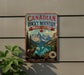 A vintage-style sign for Canadian Rocky Mountain Parks Canada, featuring a mountain landscape with a river and a bighorn sheep, mounted on a wall.