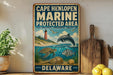A vintage metal sign for Cape Henlopen Marine Protected Area in Delaware, featuring illustrations of marine life and a lighthouse.