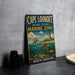 A vintage metal sign for Cape Lookout National Seashore Marine Zone, featuring an illustration of a lighthouse, a boat, and marine life, is displayed on a gray countertop.