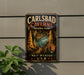 A vintage-style metal sign for Carlsbad Caves National Park, New Mexico, USA, featuring an illustration of the cave system and the park's name.