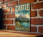 A vintage-style metal sign for Castle Provincial Park in Alberta, Canada, featuring a mountain landscape and a lake.