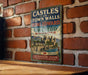 A vintage-style sign for the Castle and Town Walls of King Edward Gwynedd, located in the United Kingdom.
