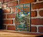 A vintage-style metal sign with the text "CASTOR RIVER SHUT-INS NATURAL AREA MISSOURI" is displayed on a brick wall.