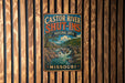 A vintage metal sign with the text "CASTOR RIVER SHUT-INS NATURAL AREA" and "MISSOURI" is displayed on a wooden wall.