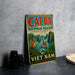 A vintage sign for Cat Ba Biosphere Reserve, featuring a tropical landscape with a monkey, boats, and text promoting the reserve as a nature sanctuary.