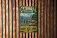 A vintage-style metal sign for Cathedral State Park in West Virginia, featuring a scenic landscape with cliffs and trees.