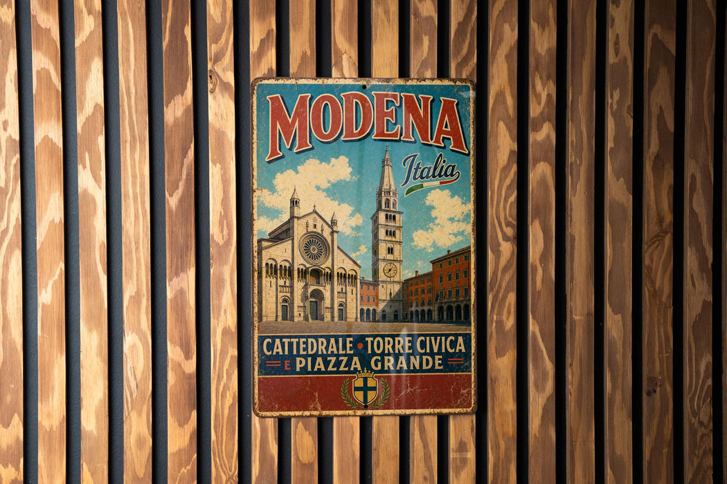 A vintage metal sign with the text "MODENA Italia" and an illustration of a church and a clock tower, hanging on a wooden wall.
