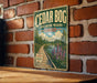 A vintage-style metal sign for Cedar Bog State Nature Preserve in Ohio, featuring a scenic illustration of a wooden boardwalk leading to a pond surrounded by trees and flowers.