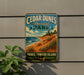 A vintage-style metal sign for Cedar Dunes Provincial Park, featuring a scenic beach landscape with pine trees and grassy hills.