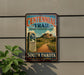 Centennial Trail sign on a wall, featuring a scenic mountain landscape and a dirt trail.