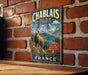 A vintage metal sign for Chablais Park in France, featuring a mountain landscape and a goat.