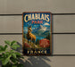 A vintage metal sign for Chablais Park in France, featuring a mountain landscape and a goat.