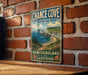 A vintage-style metal sign for Chance Cove Provincial Park, New Brunswick, Labrador, mounted on a brick wall.