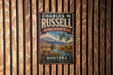 A vintage metal sign for Charles M. Russell's National Wildlife Refuge in Montana, featuring an illustration of a deer and ducks in a scenic landscape.
