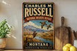A vintage-style metal sign for Charles M. Russell's National Wildlife Refuge in Montana, featuring an illustration of a deer and ducks in a scenic landscape.
