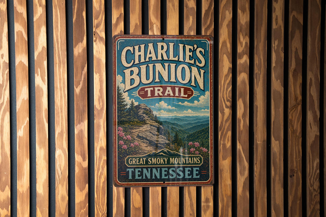 A vintage metal sign for Charlie's Bunion Trail in Tennessee, featuring a scenic mountain landscape.