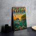 A vintage-style metal sign for the Charlotte Harbor Aquatic Preserve in Florida, featuring illustrations of marine life and a sunset over the water.