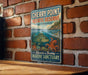 A vintage-style sign for Cherry Point Aquatic Reserve in Washington, featuring an illustration of marine life and the text "Discover a Thriving Marine Sanctuary".
