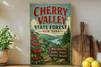 A vintage-style sign for Cherry Valley State Forest in New York, featuring a scenic illustration of cherry trees and a river.