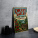 A vintage-style metal sign advertising Cherry Valley State Forest in New York, featuring a scenic illustration of cherry trees and a river.