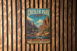 A vintage-style metal sign for Chesler Park Loop in Utah, featuring a scenic illustration of the park's natural landscape.