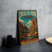 A vintage-style metal sign for Chesler Park Loop, featuring a desert landscape with mountains and a clear sky.