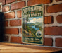 A vintage metal sign for Chester-Blandford State Forest, featuring a scenic mountain landscape with pine trees and a lake.