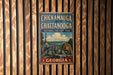 A vintage metal sign with the text "CHICKAMGAUGA AND CHATANOOGA NATIONAL MILITARY PARK GEORGIA" displayed on a wooden wall.