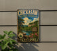 A vintage-style metal sign for Chickasaw State Forest in Tennessee, featuring a scenic landscape with pine trees, a river, and mountains.