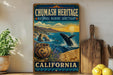 a vintage-style metal sign for the Chumash Heritage National Marine Sanctuary in California, with a whale leaping out of the water and a basket of woven baskets in the foreground.