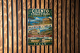 A vintage metal sign with text and images of ancient Roman architecture, including the Colosseum and other landmarks, is displayed on a wooden wall.