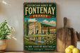 a vintage-style sign for the Cistercian Abbey of Fontenay, France, with a painting of the abbey and a pond in the foreground. The sign also includes text that reads "900 Years of Heritage" and "Peace - Simplicity - Tradition".