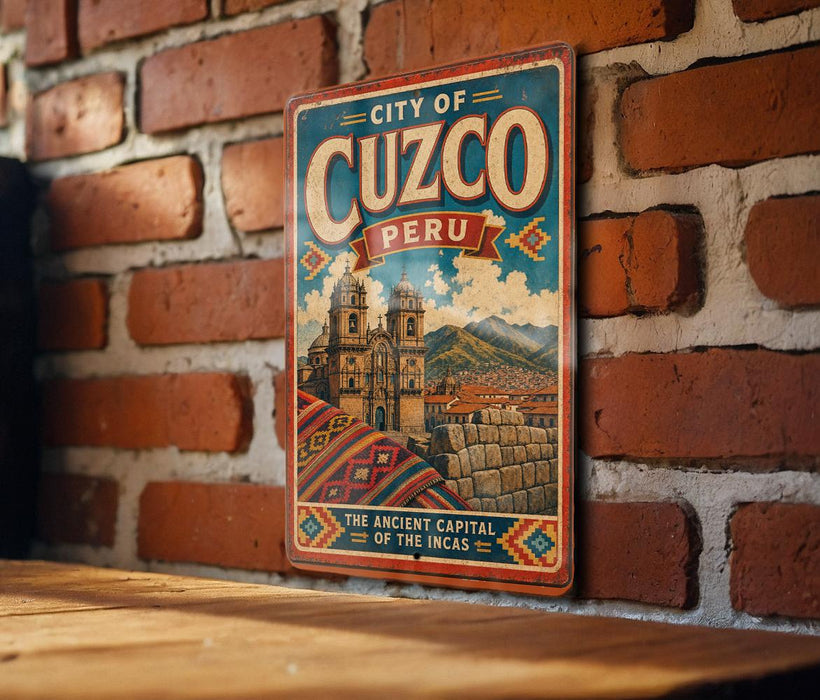 A vintage-style metal sign with the text "CITY OF CUZCO PERU" and an illustration of a historic Inca city, mounted on a brick wall.