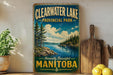 a vintage-style sign for Clearwater Lake Provincial Park in Manitoba, Canada, with a scenic landscape of pine trees, a lake, and mountains in the background.